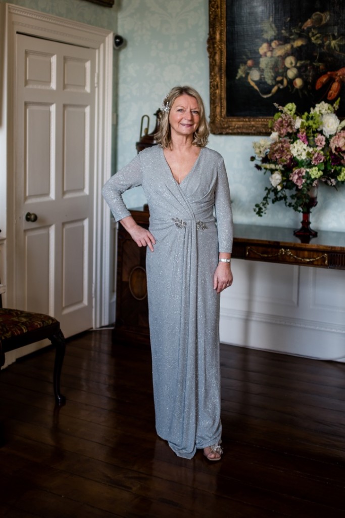 elegant long sleeved full length mother of the bride dress in dove grey with subtle sparkle by John charles