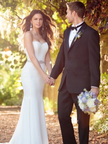 Essense of Australia D2256 plain fitted wedding dress can be styled with accessories to make it unique front view with groom.