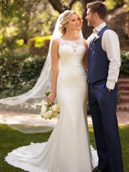 Essense of Australia D2711 plain fitted wedding dress with high neck and lace detail to the bodice train and back front view with groom.