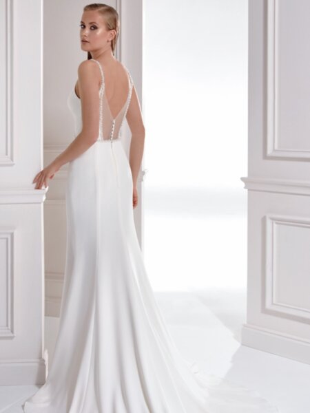 Libelle Leslie plain fitted V neck wedding dress with deaded detail at the empire line and low statement back side back view.