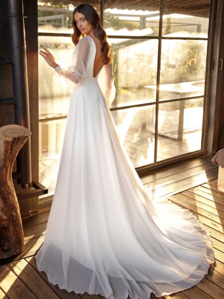 Libelle long sleeved wedding dress with low open back and train.