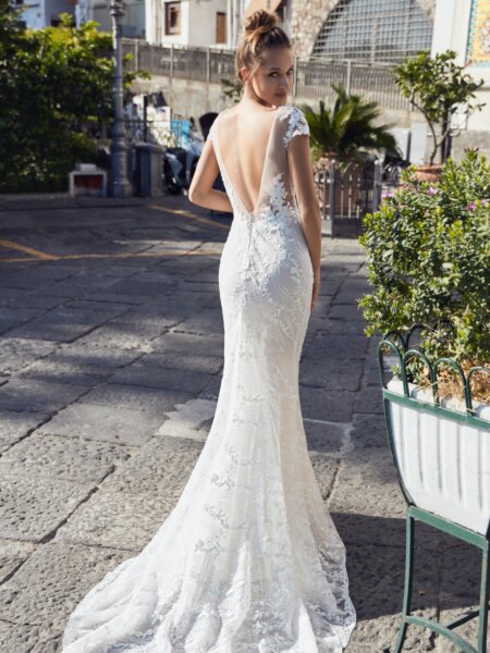 Libelle Morretta fitted lace wedding dress with low back and short train back view.