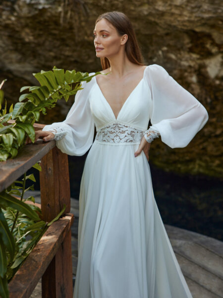 Libelle Bridal Heidy chiffon A line wedding dress with V neck long sleeves and lace detail at the waist and cuffs close up front.