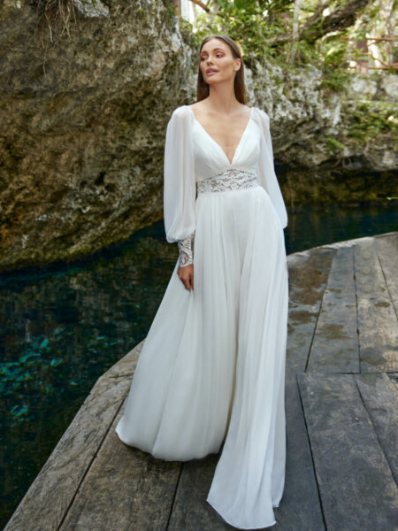 Libelle Bridal Heidy chiffon A line wedding dress with V neck long sleeves and lace detail at the waist and cuffs.