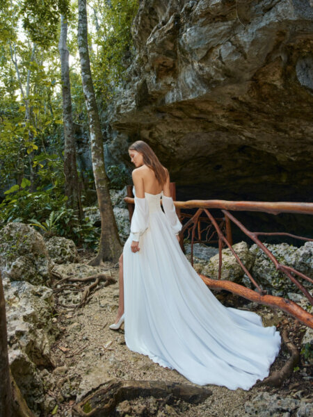 Libelle Bridal Hollis boho wedding dress with off the shoulder sleeves and floaty skirt back.