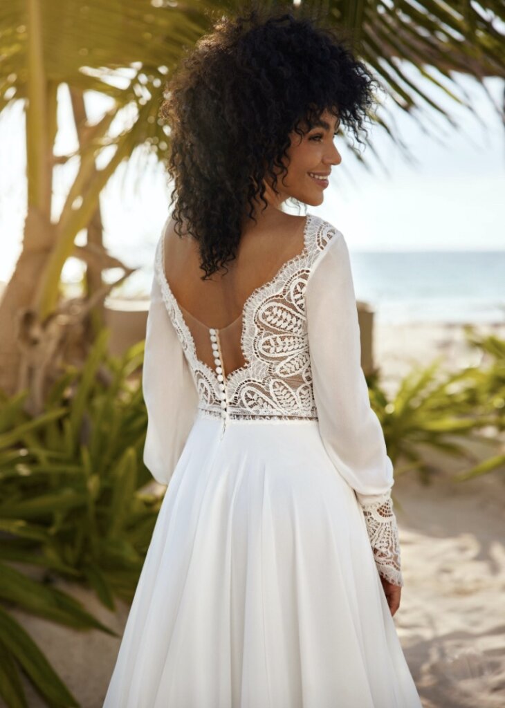 Herve Paris Becca A line wedding dress with lace bodice and long sleeves back close up.