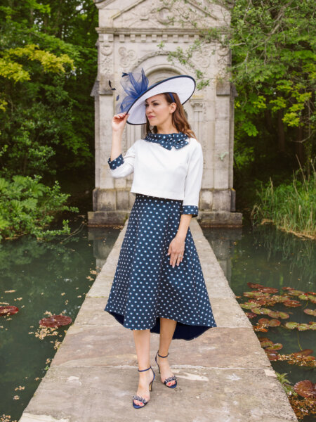 Lizabella mother of the bride A line navy polka dot dress and plain ivory jacket with polka dot detail.