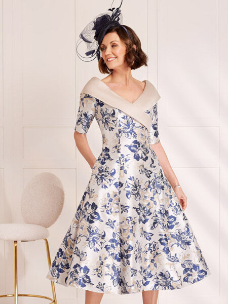 John Charles 29047 Mother of the bride A line dress with swing skirt and V neck collar in beautiful blue and oyster floral fabric.