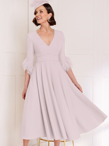 John Charles 29089 A line Mother of the Bride dress in blush pink with V neck wide waistband and three quarter sleeves with feather trim.