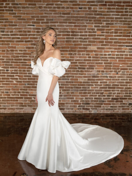 Essense of Australia D3822 plain fitted mermaid wedding dress with sweetheart neckline rouched bodice and detachable off the shoulder sleeves with bows side front view.