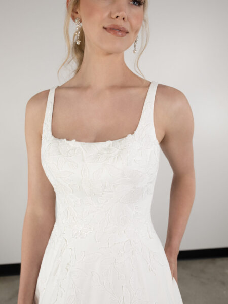 Essense of Australia plain A line wedding dress with square neckline and subtle matt lace detail front view close up.