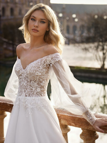 Libelle Bridal Jenniffer A line off the shoulder wedding dress with detachable blouson sleeves front close up view.