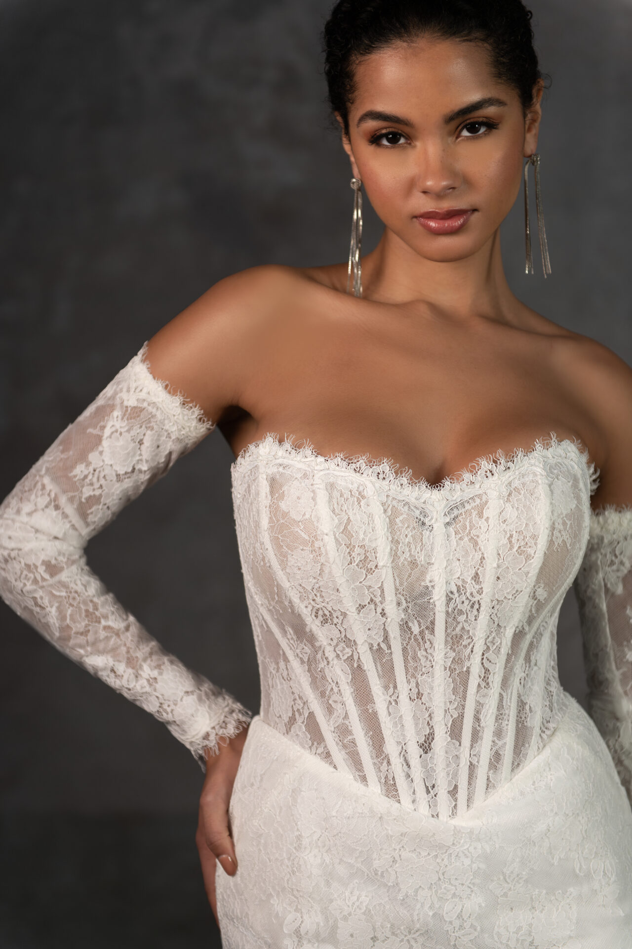 Essense of Australia D4287 fitted lace wedding dress with strapless basque bodice and detachable long sleeves close up front view.
