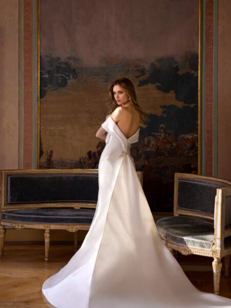 Rand Fenoli Imelda plain fitted wedding dress with Bardot off the shoulder neckline and stunning statement train back view.