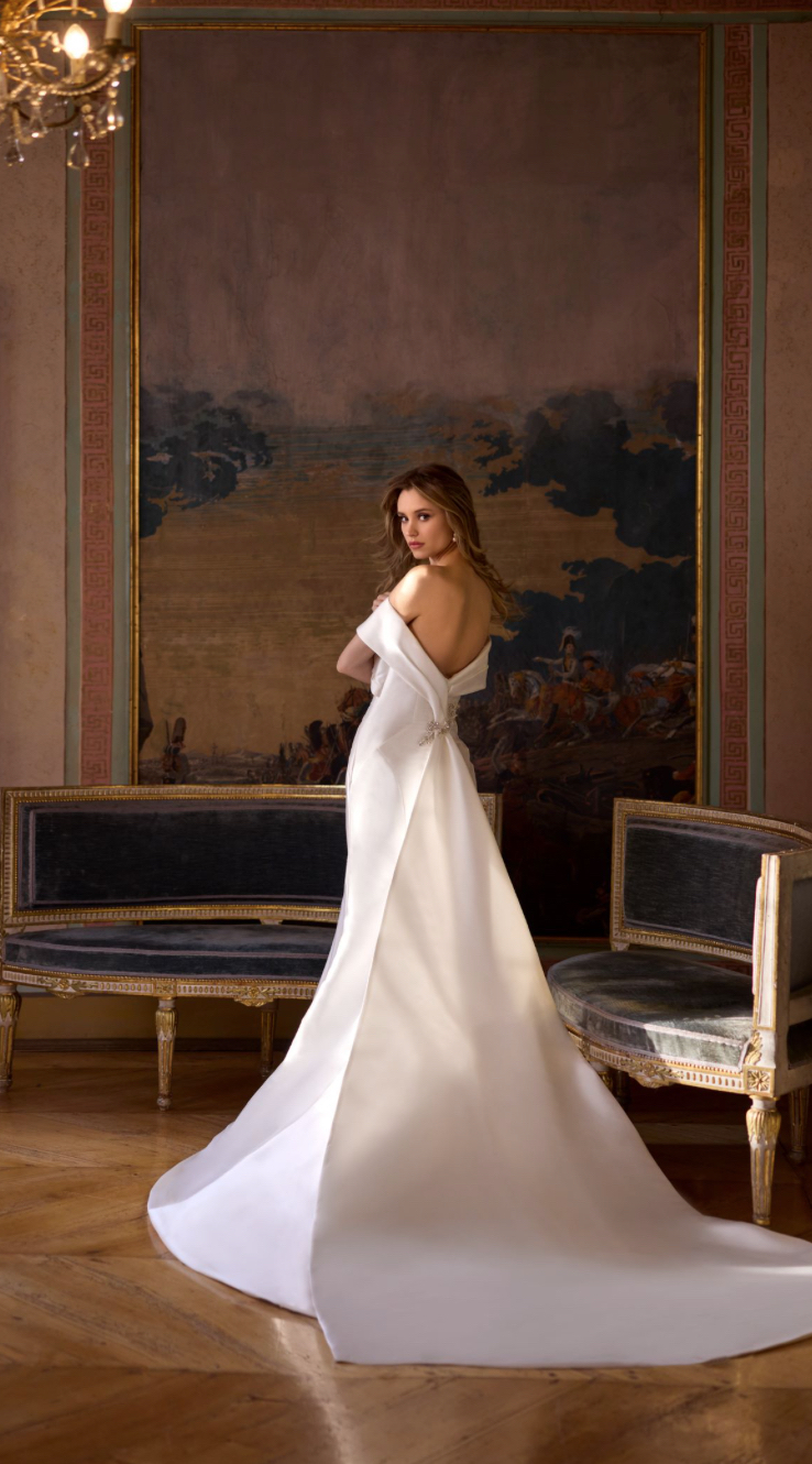 Rand Fenoli Imelda plain fitted wedding dress with Bardot off the shoulder neckline and stunning statement train back view.