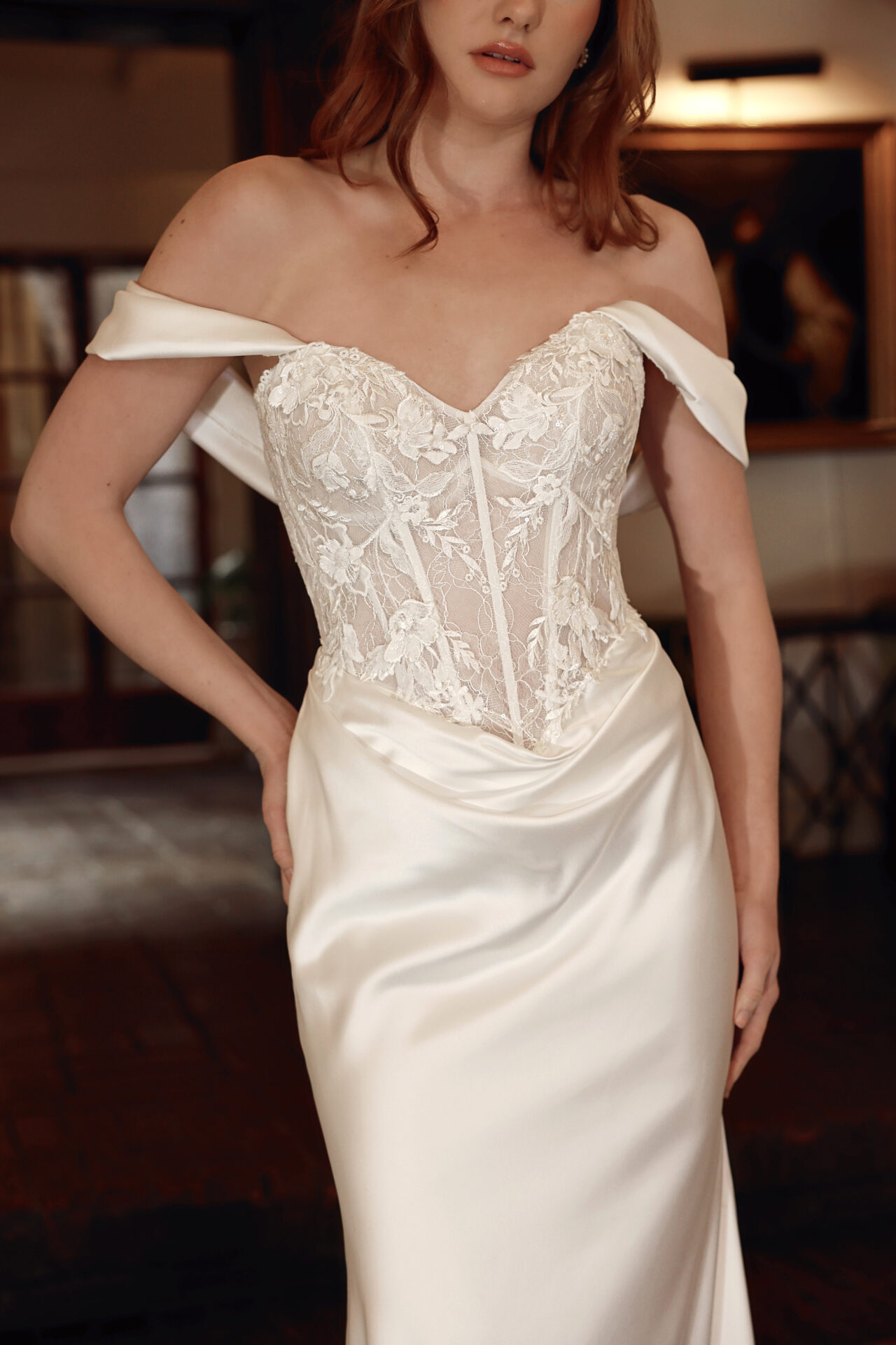 Essense of Australia D4303 fitted wedding dress with lace basque bodice plain satin skirt and off the shoulder detachable strap close upfront view.