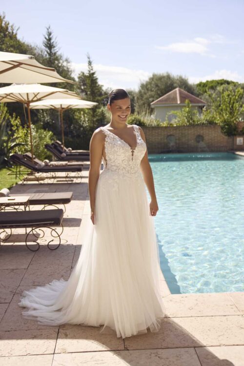 Modeca Curves Jada plus size wedding dress with plain a-line tulle skirt V neck lace bodice and detachable flutter sleeves removed front view.