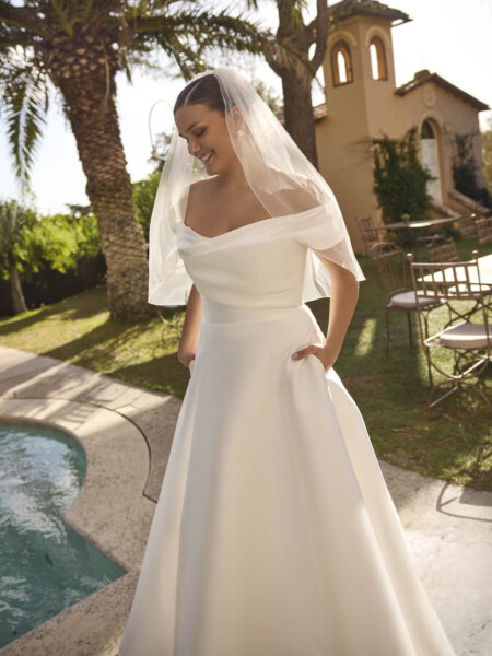 Modeca Curve collection Jolie pluse size A line wedding dress in plain mikado with off the shoulder rouched bodice and simple A line skirt front view.
