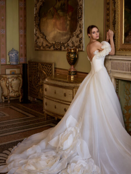 Randy Fenoli Idalia stunning plain organaza ballgown wedding dress with sweetheart neckline detachable drop floral sleeves and statement 3D floral detail on the train side view.