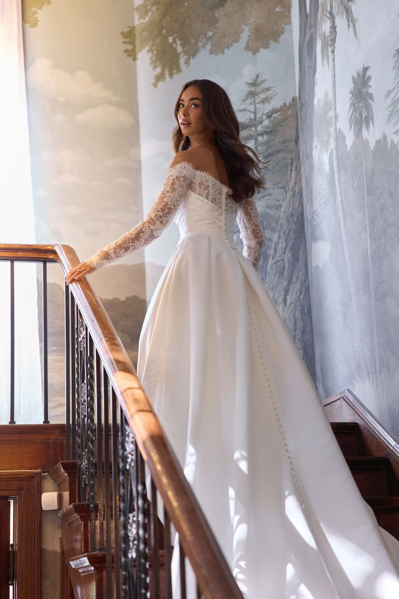 Essense of Australia D4457 plain ballgown wedding dress with rouched basque bodice with lace inset to the Bardot neckline and off the shoulder lace sleeves back view.