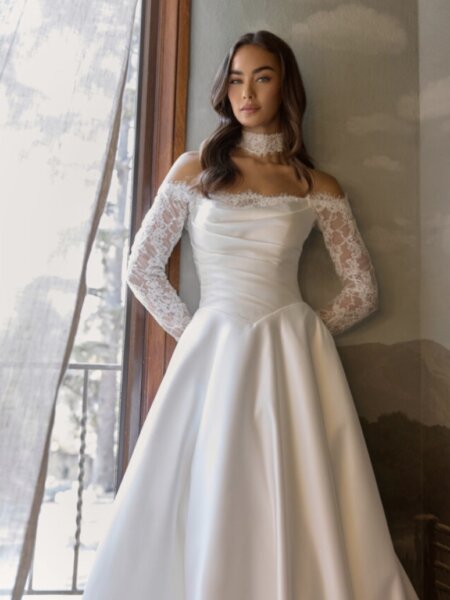 Essense of Australia D4457 plain ballgown wedding dress with rouched basque bodice with lace inset to the Bardot neckline and off the shoulder lace sleeves front view available Huddersfield bridal boutique West Yorkshire.