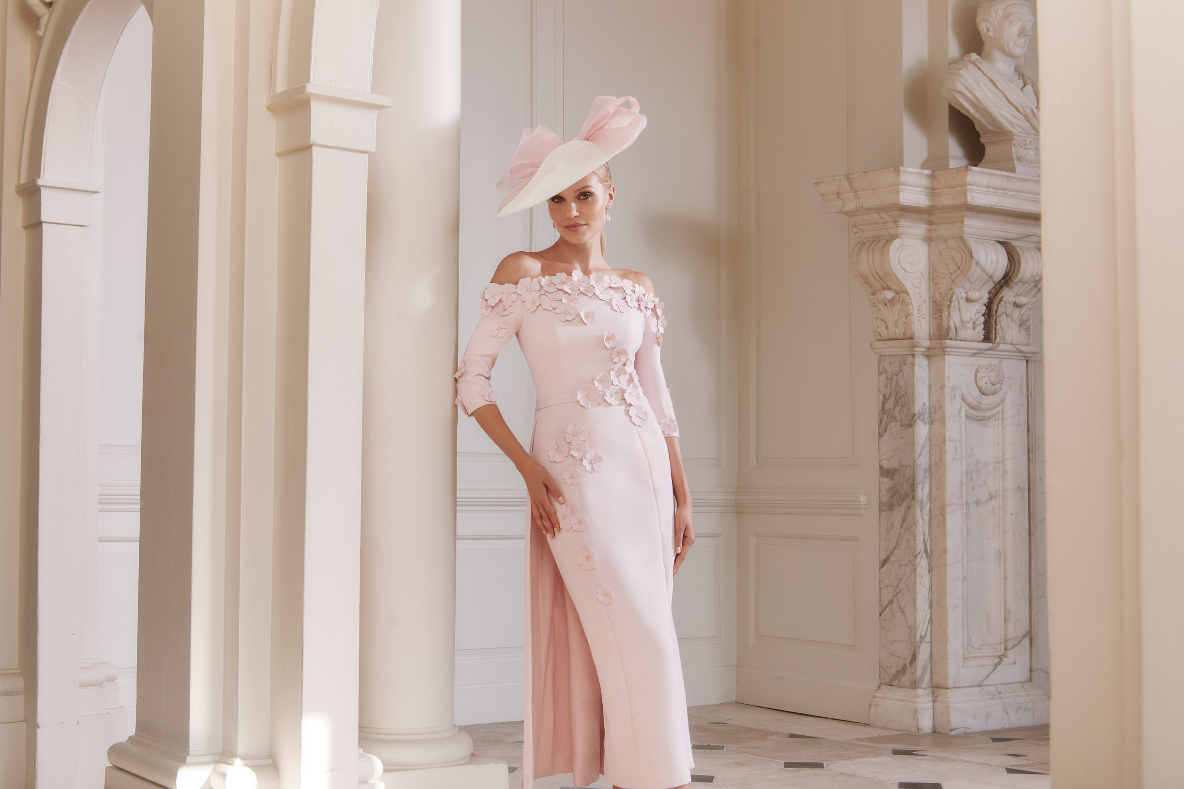 John Charles 29318 petal-pink mother of the bride dress off the shoulder fitted with overskirt and 3D floral detailModern occasion wear West Yorkshire bridal boutique near Huddersfield and Wakefield.