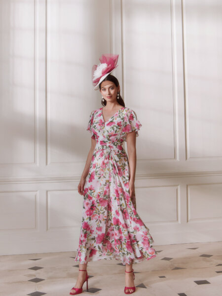 John Charles 66773 mother of the bride dress with floaty A line skirt V neckline and flutter sleeves in pretty pink floral chiffon front.