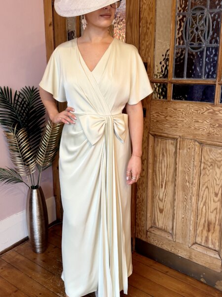 Maisonel 3116 pastel green mother of the bride dress with V neckline flutter sleeves and statement bowModern, elegant occasion wear for weddings, the races, cruises and black tie events front view matching hats, shoes and bags available. 