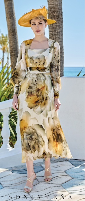 Sonia Penna 1260002 floral mother of the Bride dress in shades of amber with square neckline A line skirt and long sleevesModern, elegant occasion wear for weddings, the races, cruises and black tie events. Matching hats, shoes and bags available. 