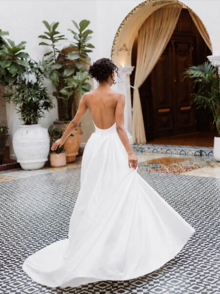Essense of Australia D4566A plain ballgown with pick up skirt at the hip. This dress has an option to be made with high neckline and long sleeves in lace front view.