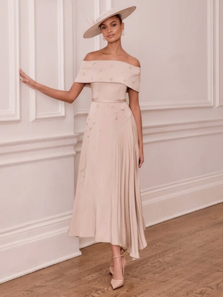 John Charles 29383 Mother of the Bride Dress in oyster with beaded Bardot neckline and asymmetric hem. Beautiful occasion wear for weddings, cruises and the races.