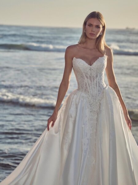 Calla Blanche Augusta wedding dress lace with fitted silhouette and plain detachable overskirt two looks in one the for perfect transformation from day to night front view.