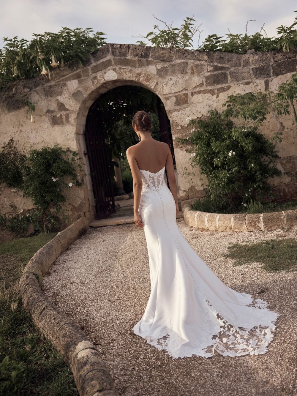 Modeca bridal Marienne fitted wedding dress with lace sweetheart bodice and plain skirt with lace edging to the train back view.
