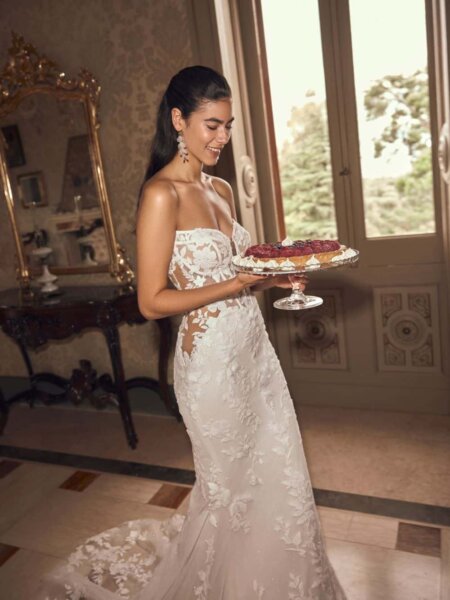 Modeca Mavie fitted lace wedding dress low illusion back and translucent side panels romantic and feminine with a hint of sexy side front view.